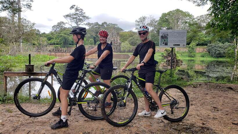 Angkor Jungle Biking Adventure Private Cycling Tour - Riding out from Siem Reap: riverside roads and community views