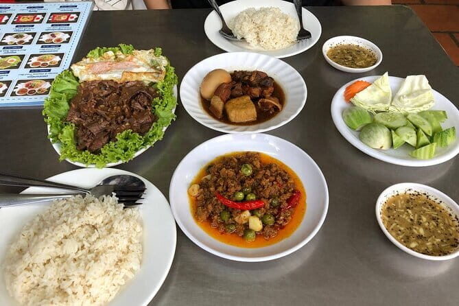 Phnom Penh Night City Highlights & Local Food tour by Tuktuk - Royal Palace at night: golden spires and calm garden time