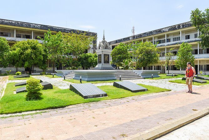 Remnants of a Khmer Rouge Era - Cheung Ek Killing Fields: memorial stupa and mass graves